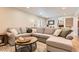 Spacious living room with large sectional couch and views of stairway at 6472 W Brittany Pl, Littleton, CO 80123