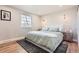 Serene main bedroom featuring hardwood floors, large window, and neutral decor at 6472 W Brittany Pl, Littleton, CO 80123