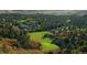 Stunning aerial view of houses nestled among lush forests and a pristine golf course at 870 Homestake Ct, Castle Rock, CO 80108