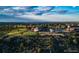 Scenic aerial view featuring lush green landscaping, a large home, and a nearby pool at 870 Homestake Ct, Castle Rock, CO 80108