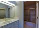 Functional bathroom featuring a tiled vanity area, and a shower with a glass door at 870 Homestake Ct, Castle Rock, CO 80108