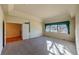 Spacious bedroom with large windows, plush carpeting and adjacent room with wood flooring at 870 Homestake Ct, Castle Rock, CO 80108