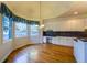 Bright breakfast nook with hardwood floors, large windows, and ample counter and storage space at 870 Homestake Ct, Castle Rock, CO 80108