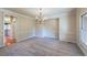 Spacious dining room with carpeted floors, chandelier, and large windows, offering a space for gatherings at 870 Homestake Ct, Castle Rock, CO 80108