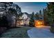 Two-story home featuring brick and siding exterior, attached garage, mature trees, and a curved driveway at 870 Homestake Ct, Castle Rock, CO 80108