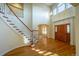Grand foyer featuring hardwood floors, curved staircase, and large front door, creating a welcoming entrance at 870 Homestake Ct, Castle Rock, CO 80108