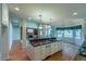 Open kitchen with island, granite counters, stainless appliances and hardwood floors at 870 Homestake Ct, Castle Rock, CO 80108