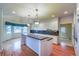Spacious kitchen with island, granite countertops, white cabinets and hardwood floors at 870 Homestake Ct, Castle Rock, CO 80108