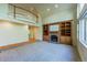 Cozy living room with a brick fireplace, custom built-ins, and a view from the second-floor balcony at 870 Homestake Ct, Castle Rock, CO 80108