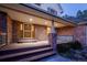 Inviting covered front porch with brick columns, wood railing and front door, creating curb appeal at 870 Homestake Ct, Castle Rock, CO 80108