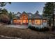 Lovely rear exterior featuring a mix of brick and siding, large windows, and a sprawling yard with mature trees at 870 Homestake Ct, Castle Rock, CO 80108