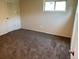 Bedroom with carpeted floor, white door, and a window at 217 Ford St, Golden, CO 80403