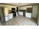 Well-lit kitchen featuring white cabinets, granite countertops, stainless steel appliances, and tile flooring at 217 Ford St, Golden, CO 80403