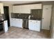 Well-lit kitchen featuring white cabinets, granite countertops, stainless steel appliances, and tile flooring at 217 Ford St, Golden, CO 80403