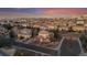 An aerial view of a residential neighborhood showcasing beautiful homes with manicured lawns and a colorful sunset at 9368 S Silent Hills Dr, Lone Tree, CO 80124