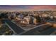 Stunning aerial view of a beautiful home in a well-developed neighborhood at dusk at 9368 S Silent Hills Dr, Lone Tree, CO 80124