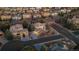 A stunning aerial view of a suburban neighborhood with well-maintained homes and mature trees at dusk at 9368 S Silent Hills Dr, Lone Tree, CO 80124