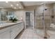 Bathroom featuring a glass shower, tile flooring, and double sink vanity at 9368 S Silent Hills Dr, Lone Tree, CO 80124