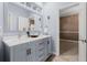 Bathroom with a modern vanity, new lighting, and an elegant mirror at 9368 S Silent Hills Dr, Lone Tree, CO 80124