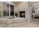 Bathroom with a soaking tub next to a fireplace, and a glass shower at 9368 S Silent Hills Dr, Lone Tree, CO 80124