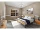 Bedroom with modern lighting, a neutral color scheme, and large windows at 9368 S Silent Hills Dr, Lone Tree, CO 80124