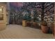 Spacious wood deck with iron railings and brick columns, surrounded by mature trees at 9368 S Silent Hills Dr, Lone Tree, CO 80124
