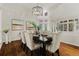 Refined dining area with hardwood floors, elegant chandelier, and neutral decor at 9368 S Silent Hills Dr, Lone Tree, CO 80124