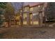 Exterior view of home with large windows, a covered deck, and a backyard patio at 9368 S Silent Hills Dr, Lone Tree, CO 80124