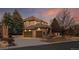 A three car garage with brick accents and mature landscaping at 9368 S Silent Hills Dr, Lone Tree, CO 80124