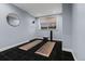 Home gym features large mirrors, black tile floors, and ample natural light at 9368 S Silent Hills Dr, Lone Tree, CO 80124