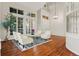 Elegant living room boasting hardwood floors, high ceilings, and natural light at 9368 S Silent Hills Dr, Lone Tree, CO 80124