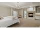 Spacious main bedroom with a fireplace, chandelier, and adjoining bath at 9368 S Silent Hills Dr, Lone Tree, CO 80124