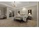 Bright main bedroom boasts a tray ceiling, chandelier, and neutral palette at 9368 S Silent Hills Dr, Lone Tree, CO 80124