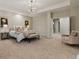 Spacious main bedroom featuring plush carpet, neutral tones, and a seating area at 9368 S Silent Hills Dr, Lone Tree, CO 80124