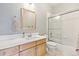 The bathroom offers a shower over tub, great lighting and a lovely mirror at 448 Winterthur Cir, Highlands Ranch, CO 80129