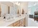 A primary bath provides dual sinks, modern fixtures and natural wood cabinets at 448 Winterthur Cir, Highlands Ranch, CO 80129