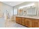 Well-lit bathroom featuring double vanity sinks, tile accents, and modern fixtures at 448 Winterthur Cir, Highlands Ranch, CO 80129