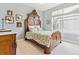 This bedroom boasts an ornate wood bedframe and a view from the lovely window at 448 Winterthur Cir, Highlands Ranch, CO 80129