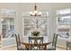 Cozy breakfast nook with a round table, four chairs, and lots of natural light at 448 Winterthur Cir, Highlands Ranch, CO 80129