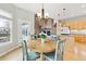 Bright breakfast nook adjacent to the kitchen, featuring views of the backyard and hardwood floors at 448 Winterthur Cir, Highlands Ranch, CO 80129