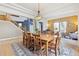 Bright dining room with hardwood floors, elegant lighting, and staircase at 448 Winterthur Cir, Highlands Ranch, CO 80129