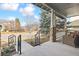 Inviting front porch featuring stone pillars, decorative railings, and comfortable outdoor seating at 448 Winterthur Cir, Highlands Ranch, CO 80129