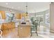 Spacious kitchen featuring an island cooktop, wood cabinets, a breakfast nook, and hardwood floors at 448 Winterthur Cir, Highlands Ranch, CO 80129