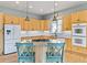 Charming kitchen with an island, granite counters, wood cabinets, and stainless steel appliances at 448 Winterthur Cir, Highlands Ranch, CO 80129