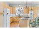 Bright kitchen with light wood cabinets, granite countertops, island cooktop, and stainless steel appliances at 448 Winterthur Cir, Highlands Ranch, CO 80129