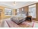 Large primary bedroom with tray ceiling, neutral colors, and ample natural light at 448 Winterthur Cir, Highlands Ranch, CO 80129