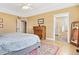 Spacious primary bedroom with en-suite bathroom, hardwood floors, and a cozy rug at 448 Winterthur Cir, Highlands Ranch, CO 80129