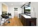 A stylish bar area with sleek countertops, modern barstools, and a pass-through window to the outdoor space at 340 Milwaukee St, Denver, CO 80206