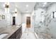 Spa-like bathroom featuring a soaking tub, dual vanity, and glass enclosed shower at 340 Milwaukee St, Denver, CO 80206