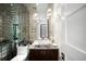 Chic powder room featuring stunning mirrored tile wall and unique marble vessel sink at 340 Milwaukee St, Denver, CO 80206